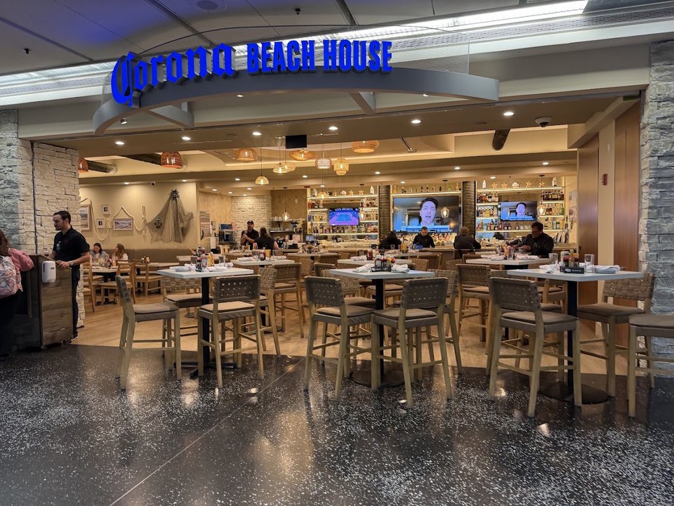 Airport dining room with warm seating and table service.