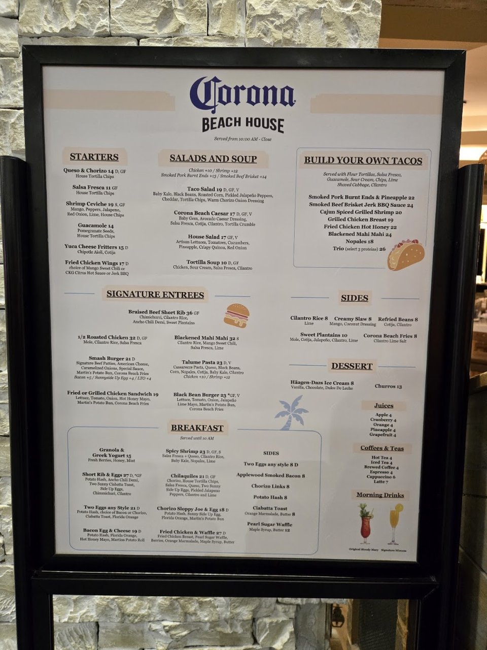Plates of New American food beside Mexican beer.